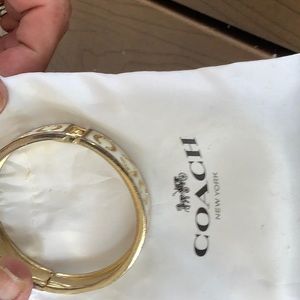 White and gold coach bracelet